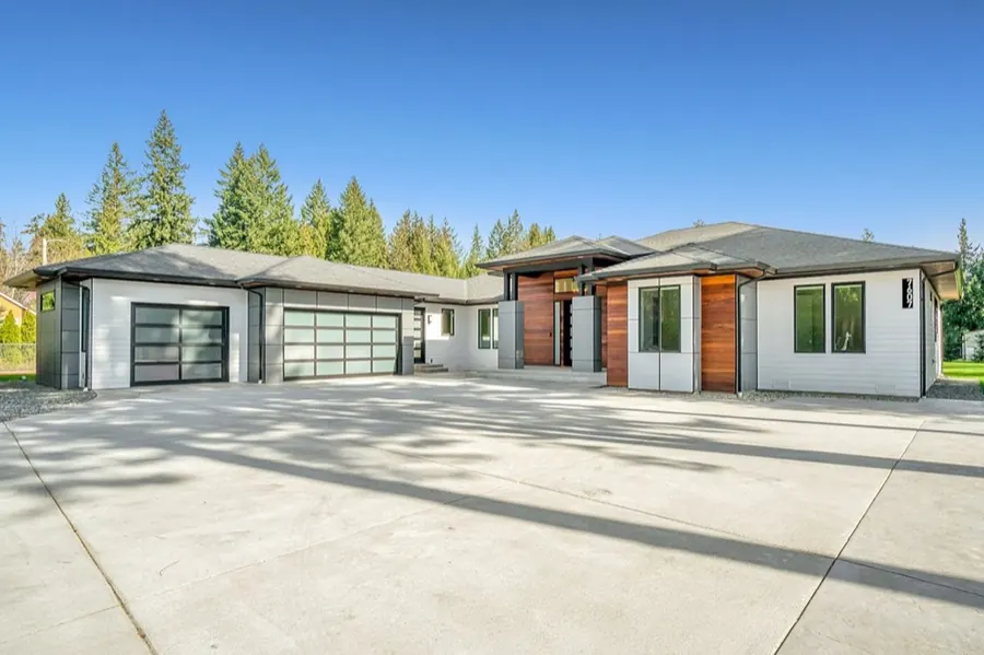 Modern full-view glass-panel garage doors on a contemporary home